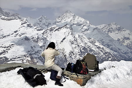 woman taking photo of snow mountain thumbnail
