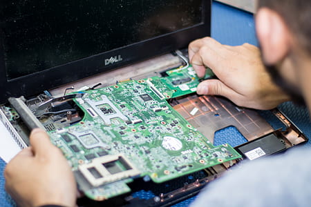 person putting green laptop circuit board thumbnail