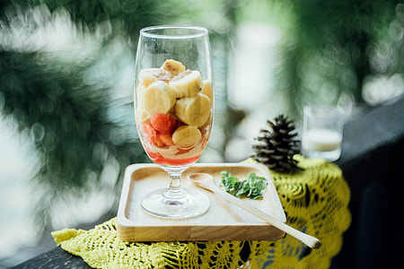 selective focus photography of fruit salad served on clear short-neck wine glass thumbnail
