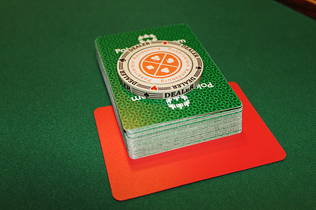 white poker chip on poker playing cards thumbnail