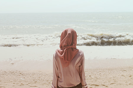 woman wearing pink hijab near body of water thumbnail