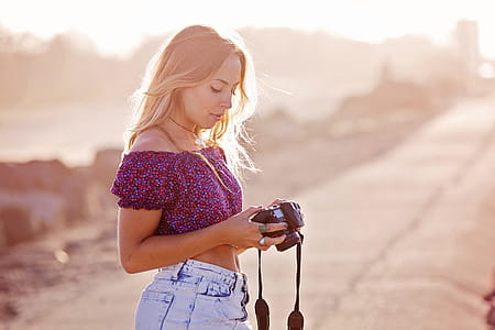 Woman Holding a Black Dslr Camera thumbnail