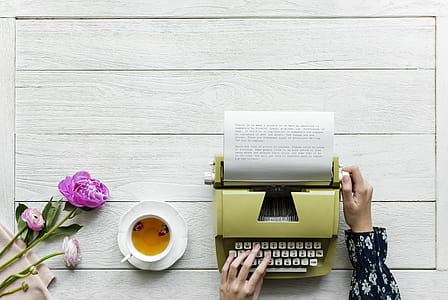 Person Using Green Typewriter thumbnail