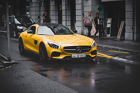yellow Mercedes-Benz coupe on concrete road thumbnail
