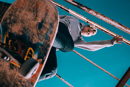 low angle photography of man playing skateboard thumbnail