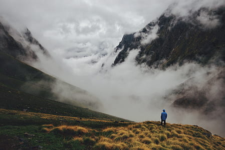 man standing on mountain with fogs thumbnail