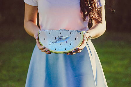 woman holding sliced fruit thumbnail