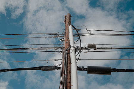 two white and brown utility poles during daytime thumbnail
