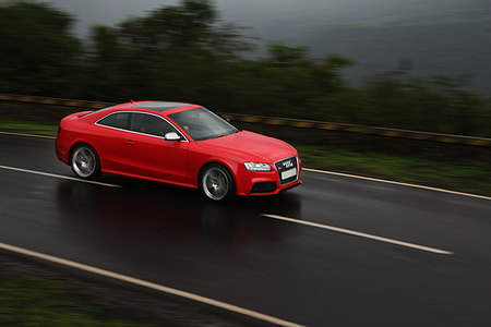 red coupe traveling on black asphalt road thumbnail