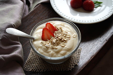 clear glass cup filled with white desert and sliced strawberry thumbnail