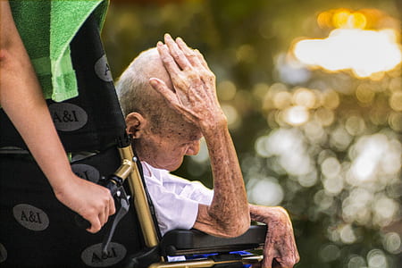 selective focus photography of man sitting on wheelchair thumbnail
