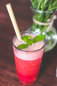 Drinking Glass With Pink Beverage And Mint Leaves thumbnail