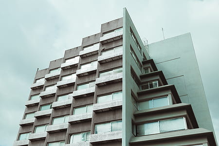 low angle photo of gray concrete high-rise building thumbnail