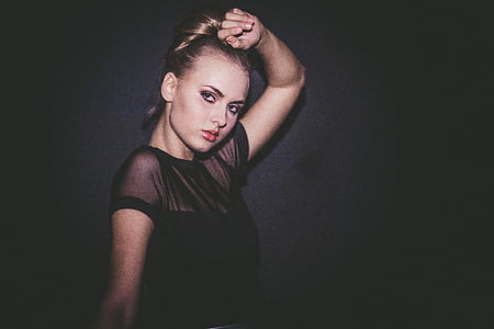 portrait photography of woman in black top with black background thumbnail