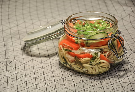 clear glass air tight jar filled with vegetables thumbnail