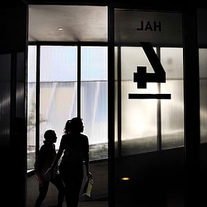 two women walking inside building thumbnail