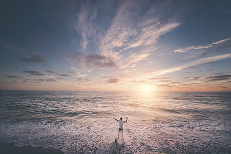 person standing facing seashore thumbnail