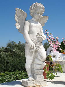 cherub statue beside white and pink petaled flowers thumbnail