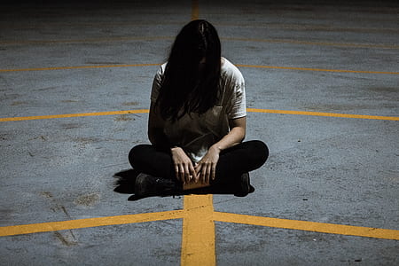 woman sitting on gray and yellow concrete floor thumbnail