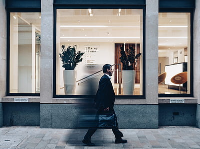 man walking on pathway passing carey Lane store thumbnail