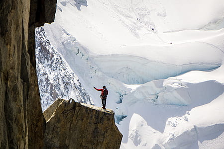 person standing on edge of mountain thumbnail