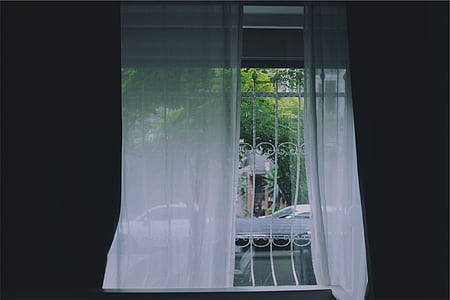 window covered with white mesh curtain thumbnail