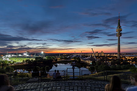 two persons fronting body of water during night time thumbnail