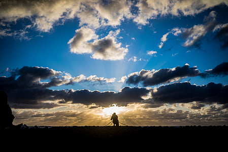 silhouette of person under blue sky thumbnail