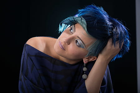 woman with short blue hair wearing blue and black off-shoulder top thumbnail