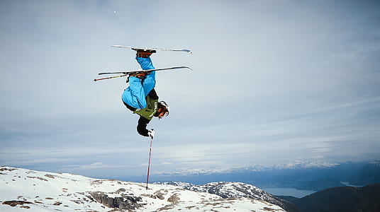 man using ski blades above snow filled ground thumbnail