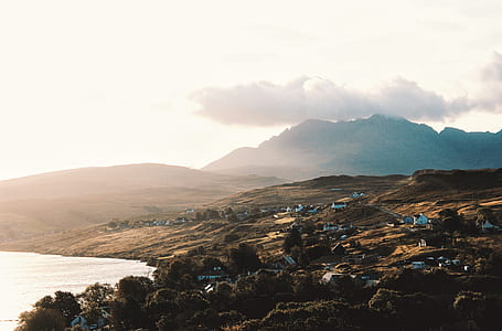 houses on hill near water during daytime thumbnail