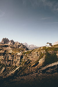 white house on rocky mountain during daytime thumbnail