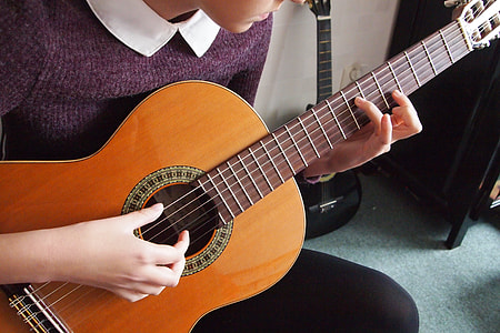 woman playing a guitar thumbnail
