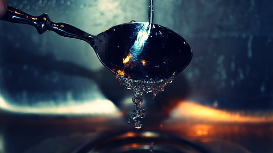 close-up photography of spoon poured with water thumbnail