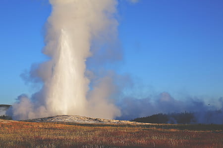 green grass field with explosion in distant thumbnail
