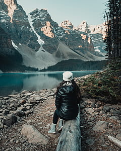 Woman Sitting on Lug Near Body of Water thumbnail