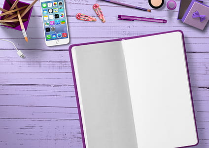drawing book besides iPhone and coloring pens thumbnail