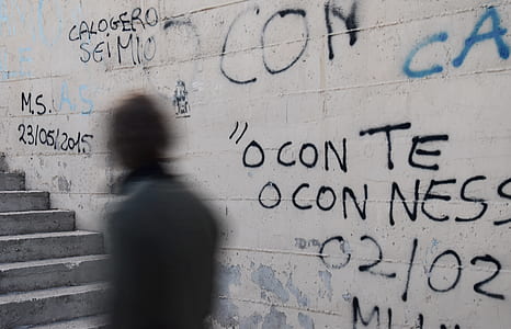 person walking on stairs beside wall thumbnail