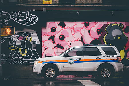 white SUV park near graffiti wall thumbnail