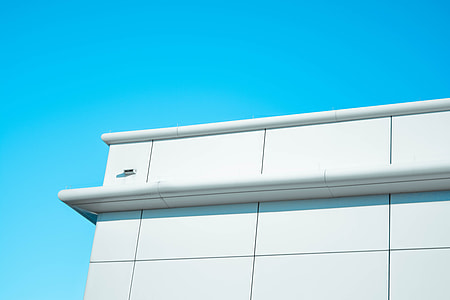 white building under blue sky thumbnail