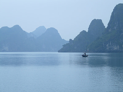boat sailing on sea near mountain thumbnail