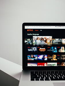 black laptop on white wooden surface thumbnail