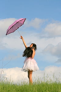 woman in pink and white sleeveless dress holding pink umbrella thumbnail