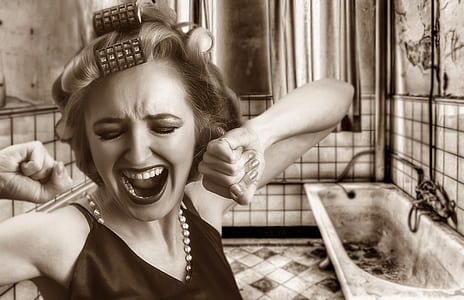 grayscale photography of woman near bathtub thumbnail