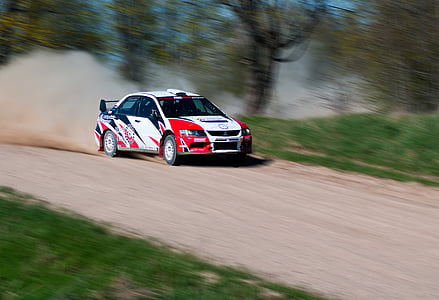 white and red stock car on rough road thumbnail