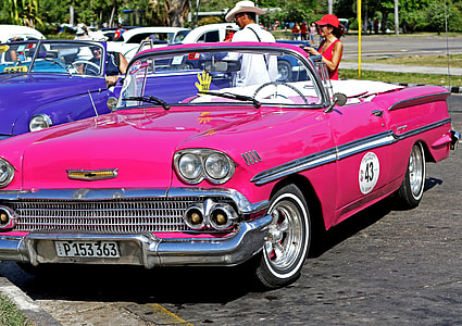 classic pink convertible car parked on parking space thumbnail