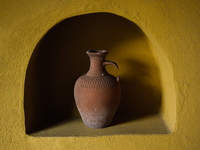 brown clay jar in yellow concrete rack thumbnail