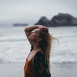 woman holding her hair near sea shore thumbnail