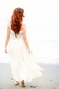woman in white dress by the seashore photo thumbnail