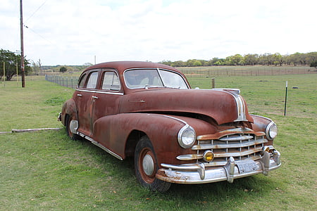 abandoned classic brown sedan on grass field at daytime thumbnail